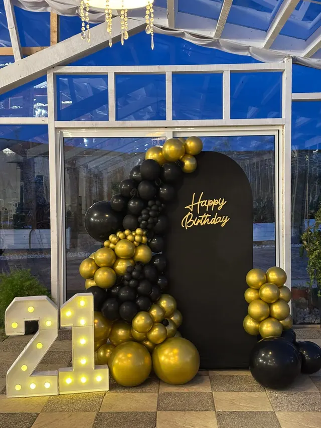 Décoration d'anniversaire noir et or : arche Happy Birthday, ballons dorés et chiffres lumineux 21